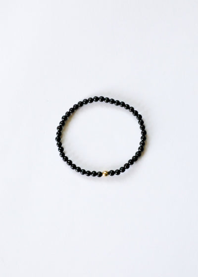 Pulsera elástica de cuentas de shungita delicada y oro de 14 quilates
