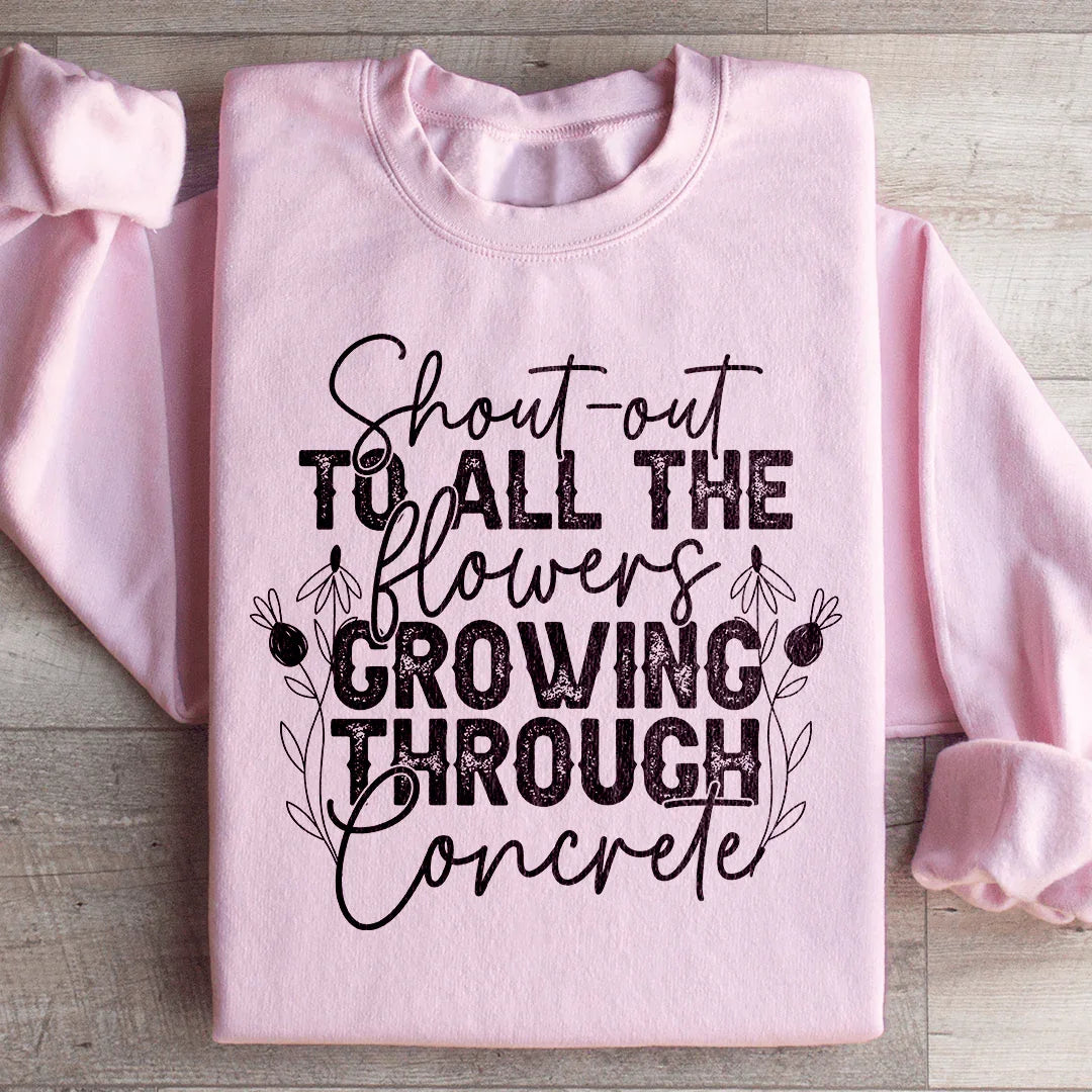 Sudadera con un saludo a todas las flores que crecen a través del hormigón