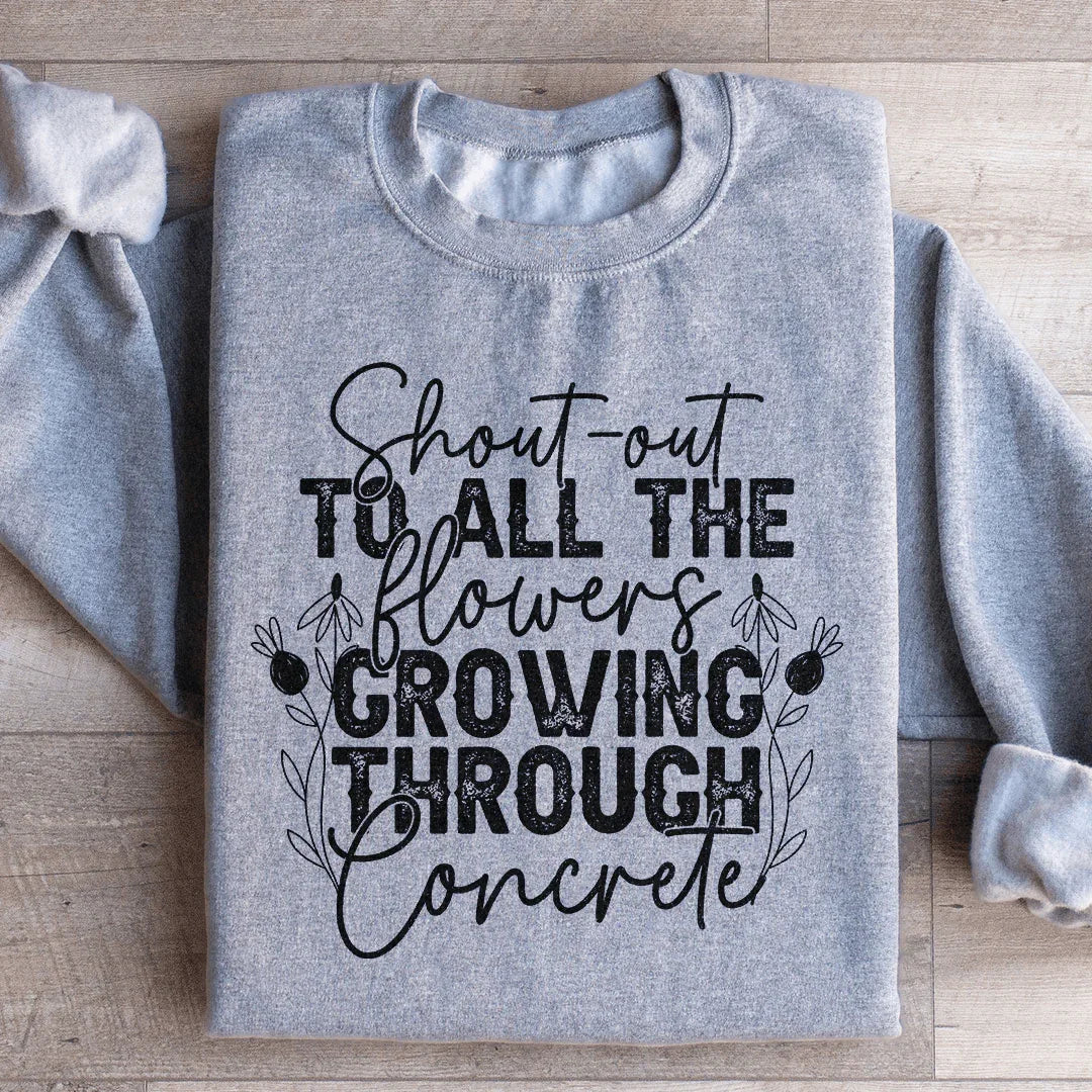 Sudadera con un saludo a todas las flores que crecen a través del hormigón