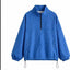 Chaqueta con capucha de media cremallera y lunares a la moda