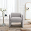 Armchair with wavy armrests, metal decorations on both sides of the armrests, made of Teddy cloth, light gray - Korvel