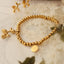 Pulsera con encanto de cachorro de acero de titanio chapado en oro de 18 quilates