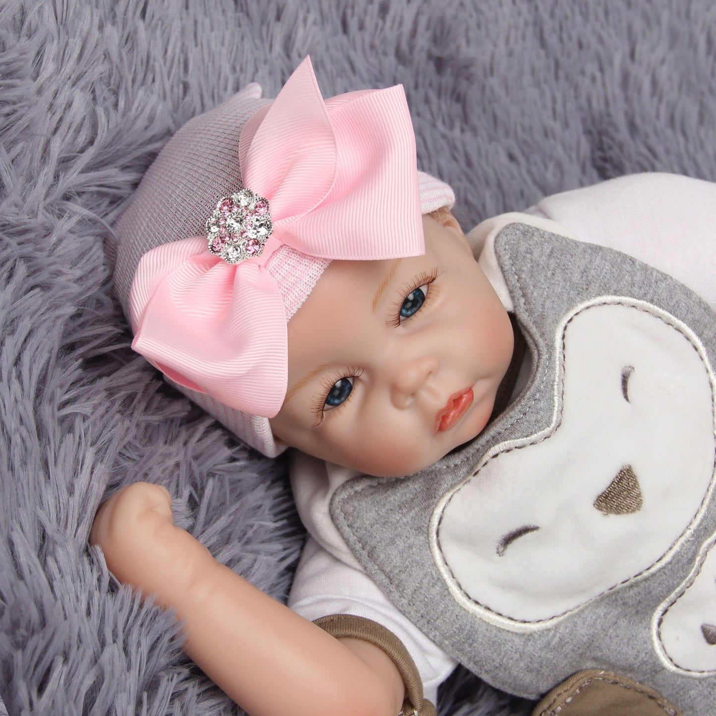 Chapeau en tricot rayé rose scintillant pour bébé avec un grand nœud