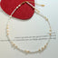 Collier en perles de verre en acier titane