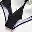 Elegante traje de baño de una pieza en blanco y negro con detalle de lazo