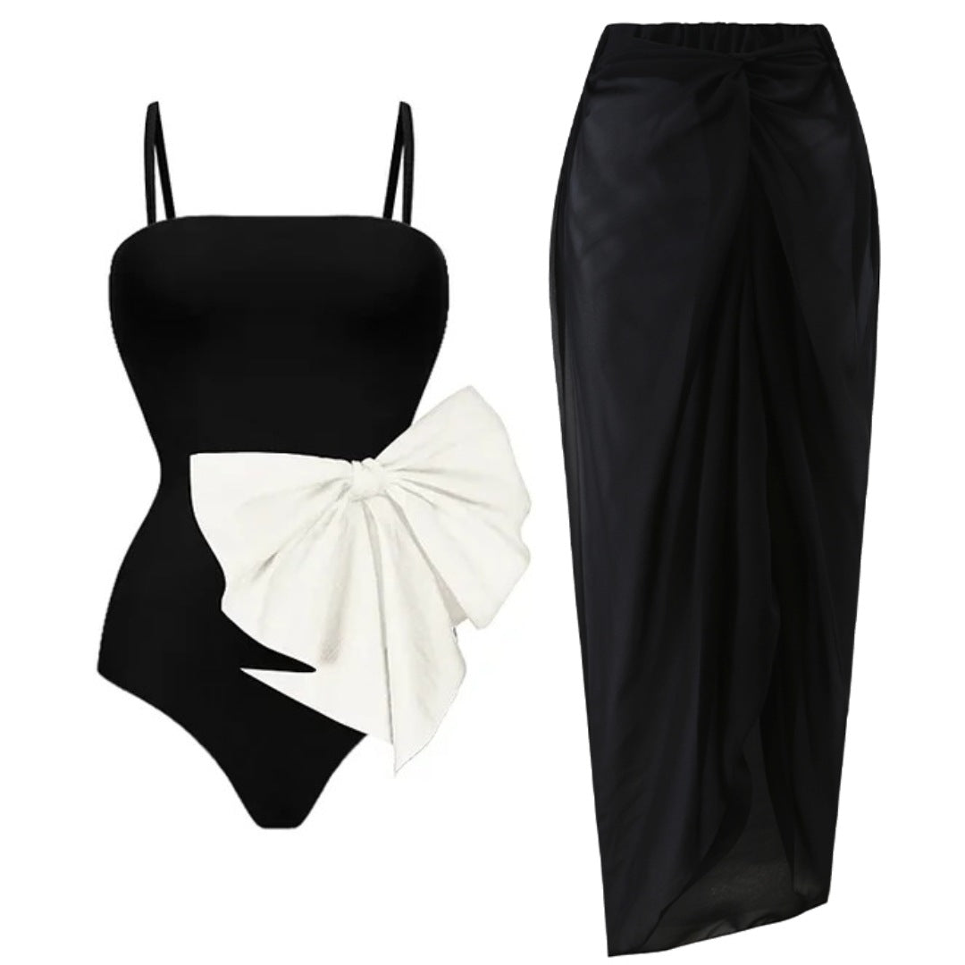 Elegante traje de baño de una pieza en blanco y negro con detalle de lazo