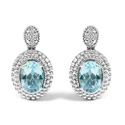 Pendientes Colgantes de Topacio Azul y Acento de Diamante en Plata de Ley .925