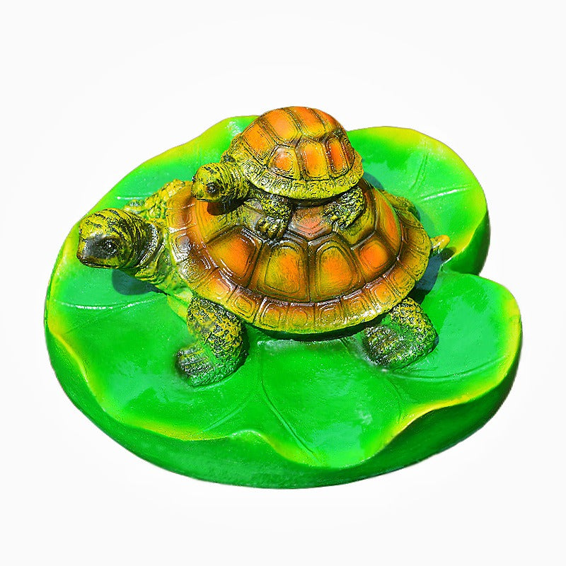 Turtle resin ornaments floating on the water surface - Korvel