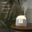 Humidificateur de nuit en forme de maison enneigée