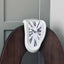 Twisted Corner Clock: Retro Melting Design with Roman Numerals