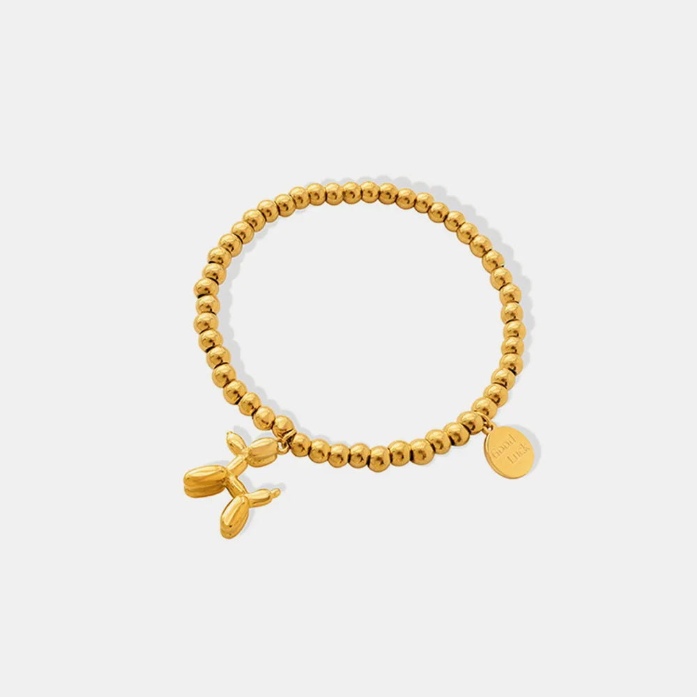 Pulsera con encanto de cachorro de acero de titanio chapado en oro de 18 quilates