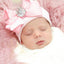 Chapeau en tricot rayé rose scintillant pour bébé avec un grand nœud
