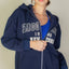 Sudadera con cremallera y hombros caídos gráficos
