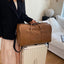 Elegante bolsa de viaje de duffel con textura de PU en colores sólidos