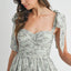 Robe midi froncée à buste floral avec lien d'épaule