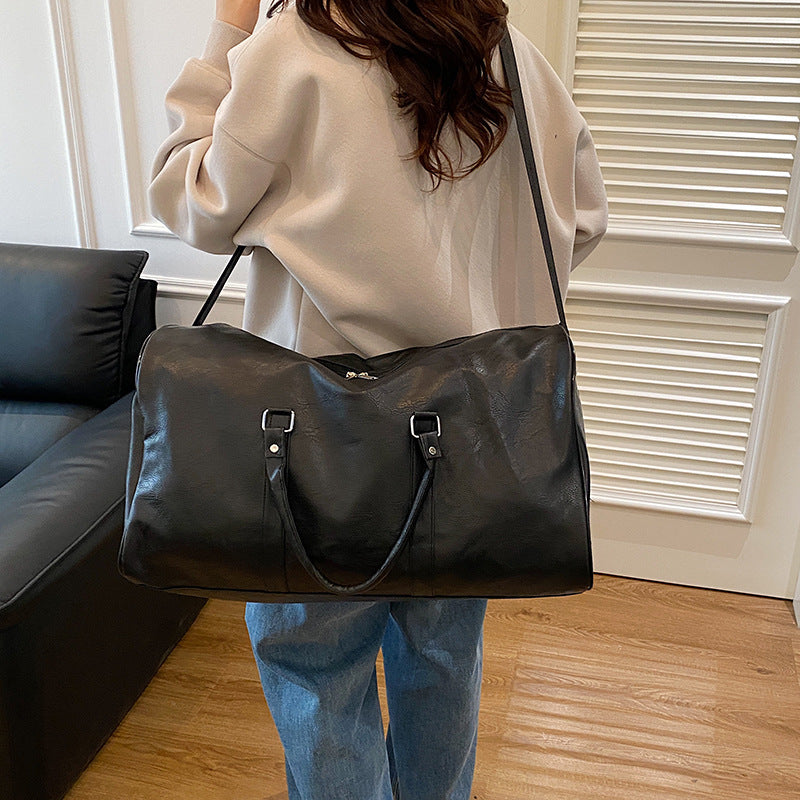 Elegante bolsa de viaje de duffel con textura de PU en colores sólidos