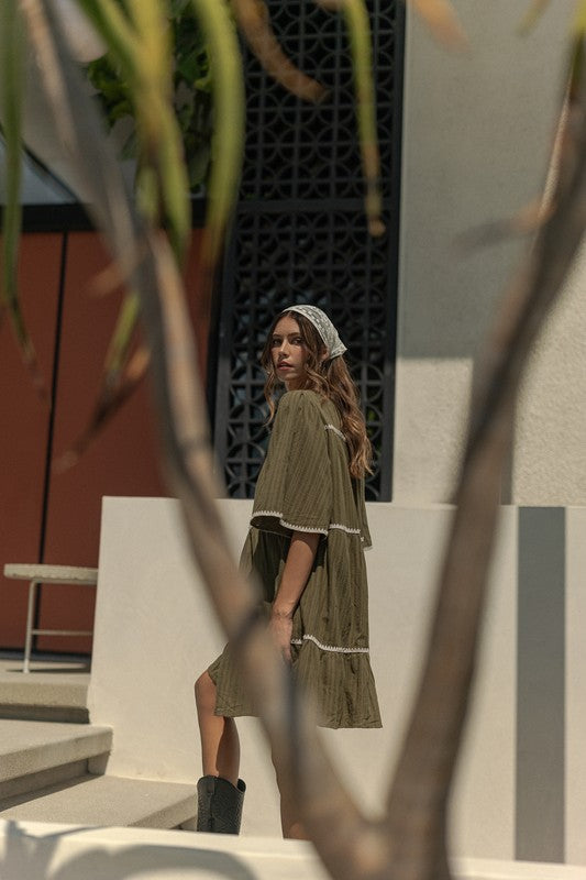 Chic Bohemian Tiered Dress with Tassel Details and Contrast Trim - Korvel