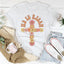 Camiseta cruzada floral "Él ha resucitado"