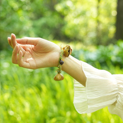 La Danseuse des Prairies - Bracelet tressé jaune et vert avec des clochettes en graines naturelles