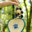 The Lucky Breeze - Hand-Woven Heart Palm Fan with Blue Elephant Charm