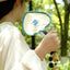 The Lucky Breeze - Hand-Woven Heart Palm Fan with Blue Elephant Charm