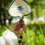 The Lucky Breeze - Hand-Woven Heart Palm Fan with Blue Elephant Charm