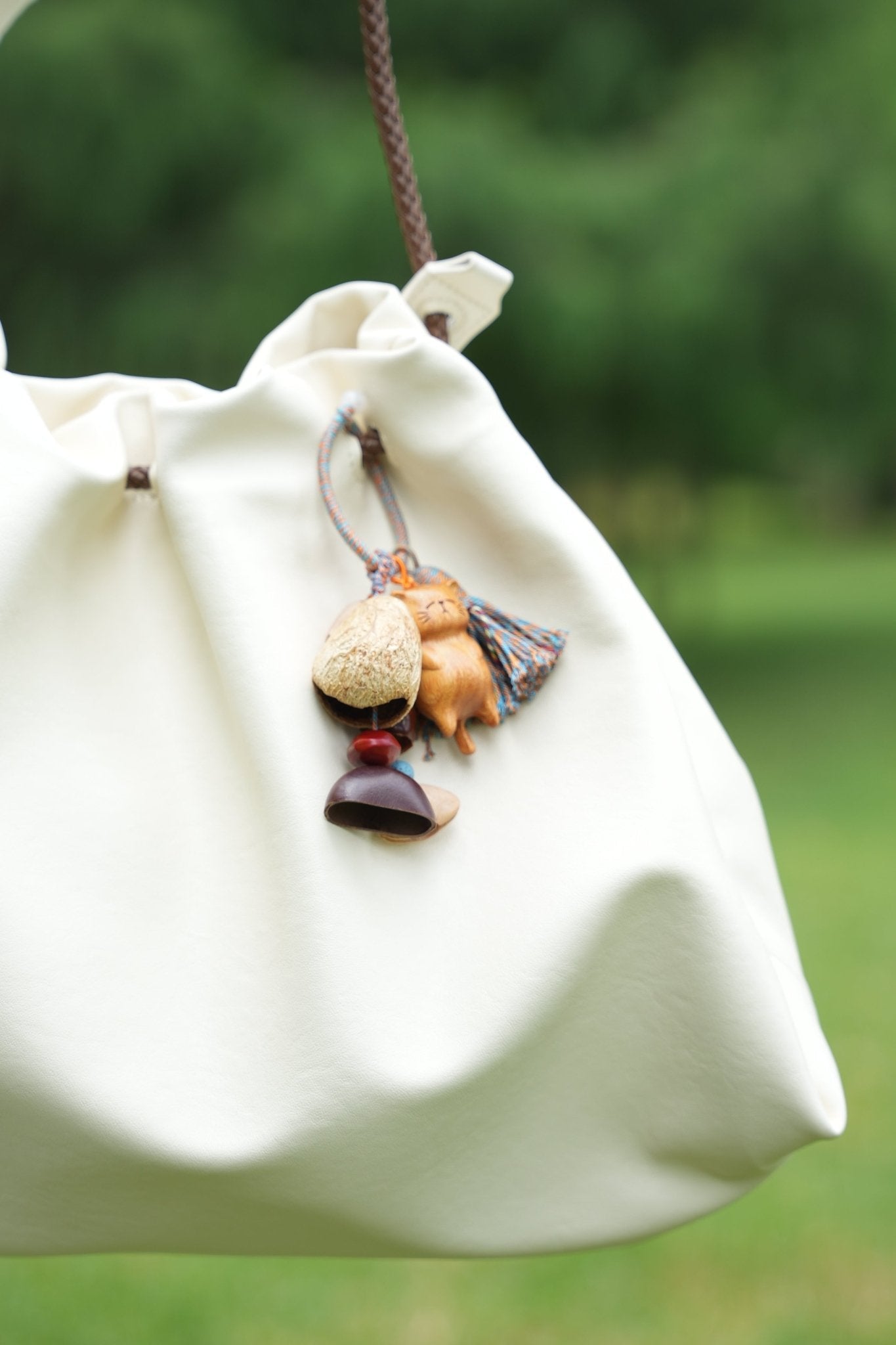 The Naptime Kitty - Hand-Carved Wooden Cat Charm with Natural Seeds & Tassel
